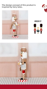 Detail of 36cm wooden gingerbread nutcracker holding a striped candy cane on a stand