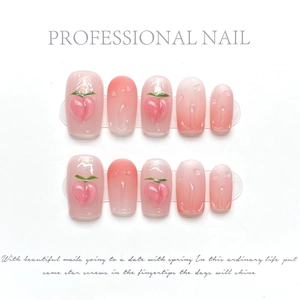 Detailed view of 3D peach charms and realistic water drops on pink gradient press-on nails