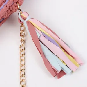 Handmade woven crossbody bag with colorful tassels and a fine gold metal chain strap
