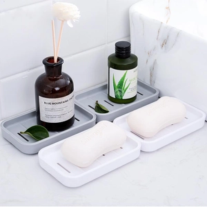 Dual-layer drainage soap holder in grey and white on a marble countertop for bathroom