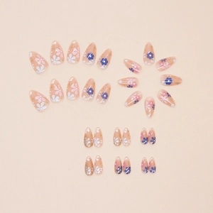 Short almond press-on nails with cute floral patterns in pink and purple tones