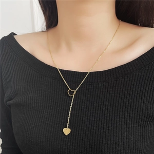 Gold stainless steel Y-shaped necklace with heart pendants worn on a model
