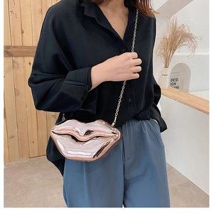 Chic rose gold lip-shaped hard shell clutch bag with a sleek metal chain strap