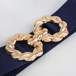 Close-up of navy blue elastic waist belt with an interlocking gold twist buckle detail