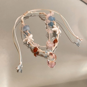 Detail of bohemian woven bracelet with colorful natural stones and starfish charms
