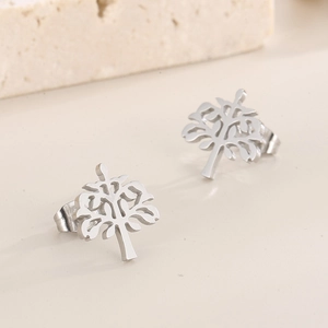 Macro view of polished silver tree of life earrings with intricate hollow design