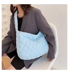Macro detail of quilted diamond pattern on light blue large-capacity tote bag