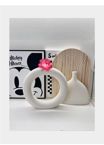 Modern matte white ceramic vases in circular and streamlined shapes for home decor
