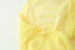 Detailed close-up of yellow mesh fabric texture on slim-fit long maxi dress