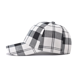 Detail of thickened black and white houndstooth pattern on the curved baseball cap brim