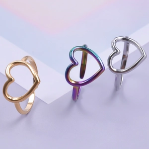 Three minimalist stainless steel open heart rings in gold, silver, and iridescent purple finish