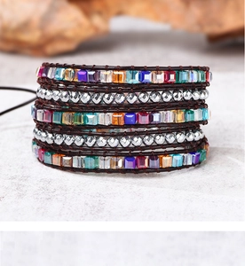 Detail of bohemian wrap bracelet with colorful crystals and silver beads on leather cord