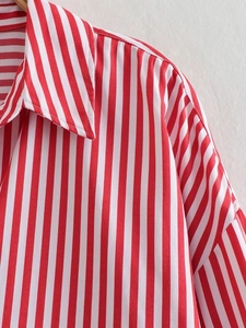 Close-up of the red and white striped poplin shirt showing neckline and shoulder detail