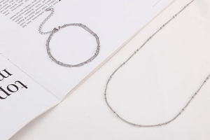 Detailed view of silver stainless steel multi-layer curb chain and bead jewelry set