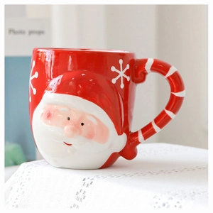 Detail of 3D Santa Claus ceramic mug with a candy cane handle and festive snowflake motifs