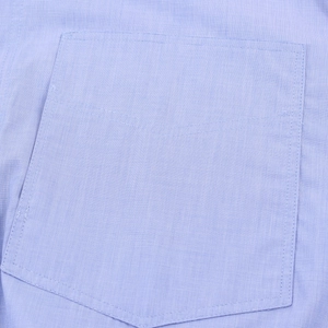 Detailed close-up of light blue cotton striped shirt pocket with precise stitching details