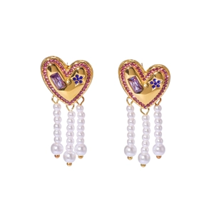 Golden heart earrings with colorful gemstones and pearl tassel pendants on white background