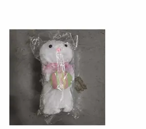 Detail shot of the white plush Easter bunny ornament in transparent plastic packaging