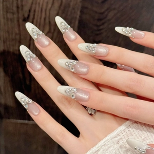Long almond cat-eye press-on nails with French white tips and heart rhinestone accents