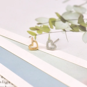 Minimalist S925 silver heart stud earring set in gold and silver finish on display