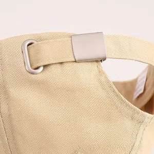 Detailed close-up of cotton twill baseball cap with silver adjustable metal buckle