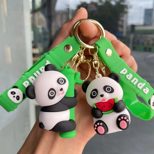 Cute panda keychains with green wristbands holding bamboo and watermelon in hand