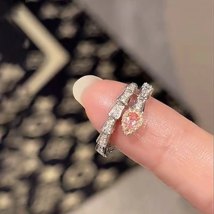 Macro shot of silver snake ring with pink teardrop stone and pavé crystal details