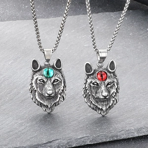 Vintage Fenrir wolf head pendant with gemstone eyes and antique finish on rock