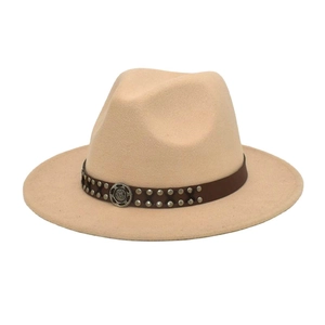 Detail of beige wool jazz hat featuring a brown leather band and silver metallic studs
