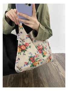 Detail of vintage floral pattern on canvas tote bag with side label and soft texture