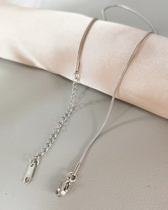 Detailed close-up of a silver stainless steel snake chain with S-hook and extension