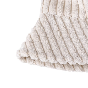 Macro detail of soft cream corduroy fabric texture with vertical striped pattern