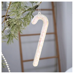 Sparkly white candy cane Christmas ornament with colorful sequins hanging on a tree branch