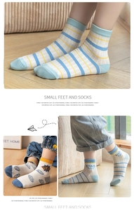Detail of breathable mesh kids' socks with UFO and Dinosaur patterns in soft pastel colors