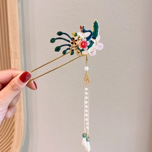 Detail of golden peacock hair stick with colorful enamel flowers and long pearl tassels