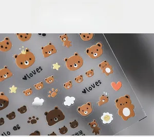 Detail shot of 5D cute brown bear and heart motifs on adhesive nail art stickers