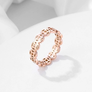 Detail shot of a rose gold Chinese coin lucky charm ring with polished finish