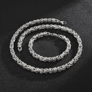 Detail of silver stainless steel Byzantine chain set with textured woven necklace and bracelet