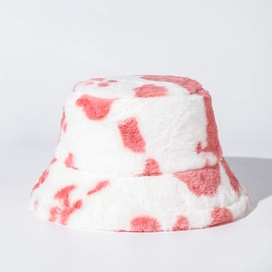 Detail of soft pink cow print plush bucket hat with fuzzy faux fur texture and warm fabric