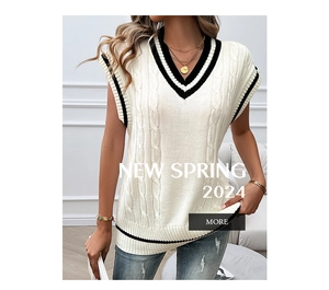 Detail of cable knit texture and black contrast trim on white V-neck sweater vest