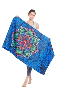 Detail of vibrant blue microfiber beach towel featuring a colorful mandala floral pattern
