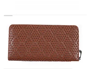 Detail view of brown long wallet with woven lattice texture and metal zipper