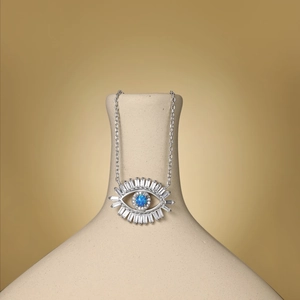 Macro shot of S925 sterling silver evil eye necklace with blue opal and radiant white zircon