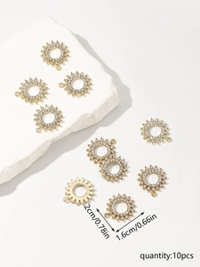 Close-up of 10-piece gold sunburst charms with rhinestones and precise size markers
