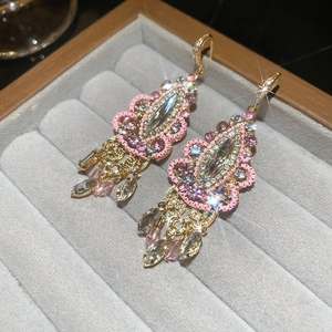 Detailed macro shot of vintage court style long tassel earrings with pink rhinestones