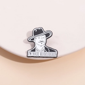 Black and white metal enamel pin featuring 'I'M YOUR HUCKLEBERRY' cowboy quote