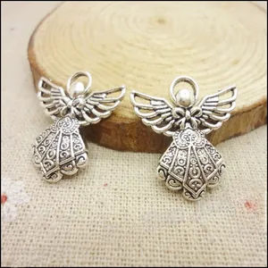 Detailed view of vintage silver angel wing charms for DIY jewelry making and crafts