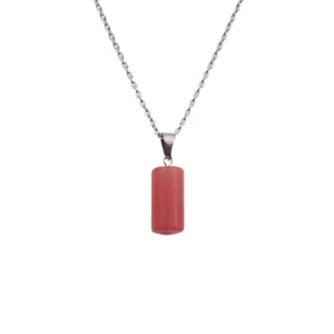 Close-up of pink cylindrical stone pendant with polished silver-tone chain necklace