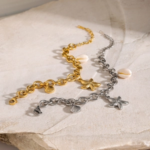 Minimalist 18k gold and silver starfish shell charms on thick chain bracelets