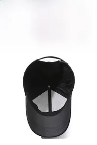 Close-up of black baseball cap showing breathable mesh back and adjustable strap detail